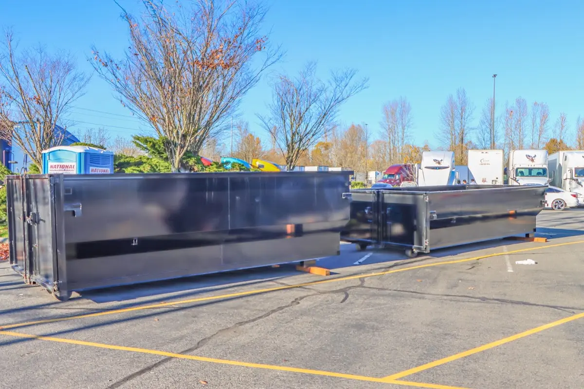 Professional dumpster rental service with roll-off container on residential driveway in Mechanicville